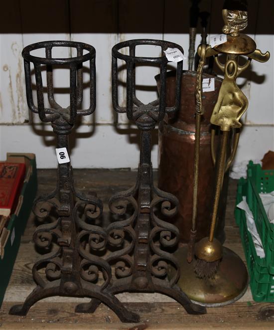 A pair of wrought iron firedogs, a copper jug, a brass companion set and sundry fire irons